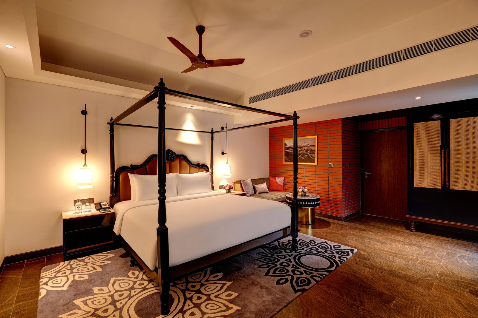 Warmly lit bedroom with a four-poster bed