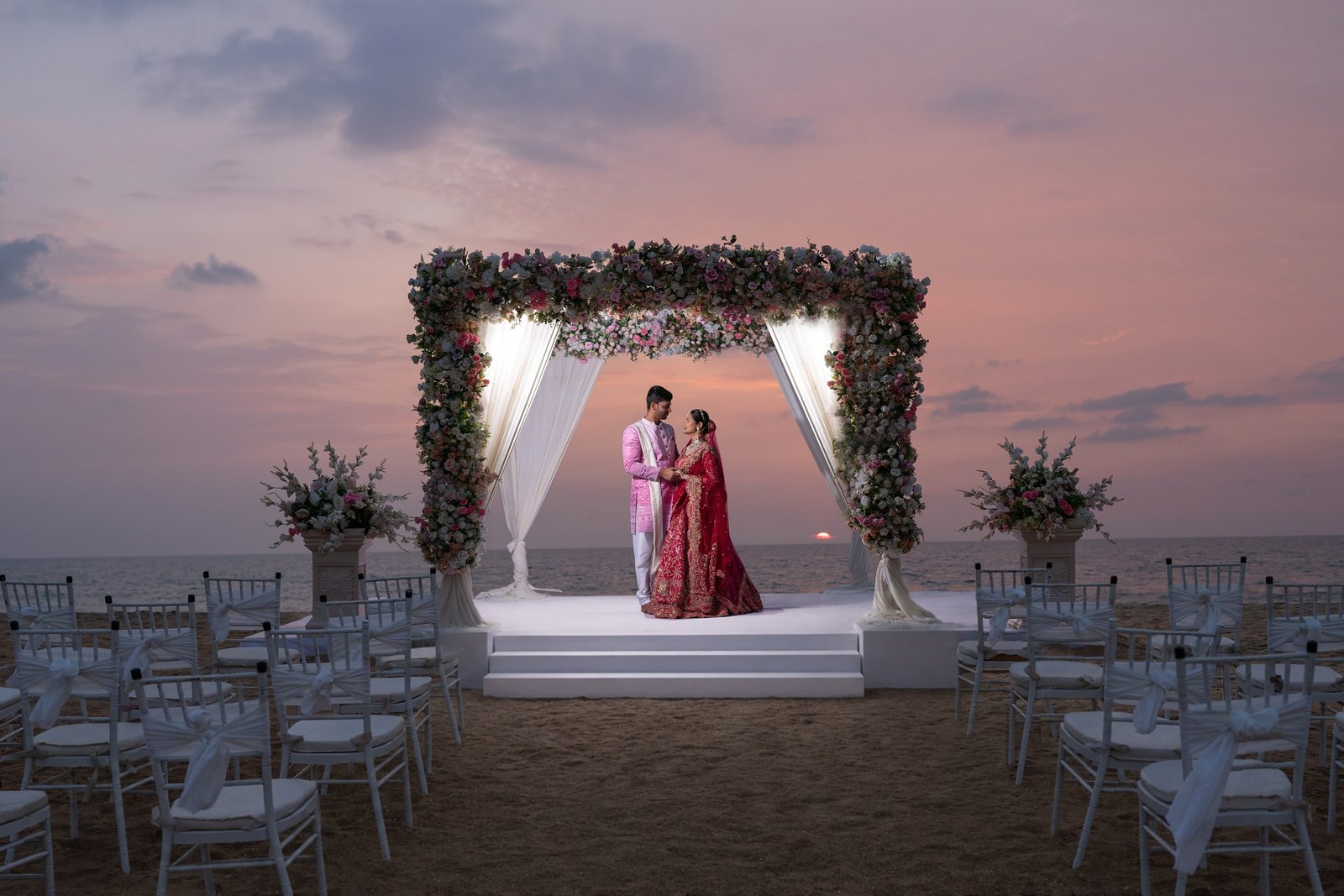Couple at a beachside ceremony at dusk