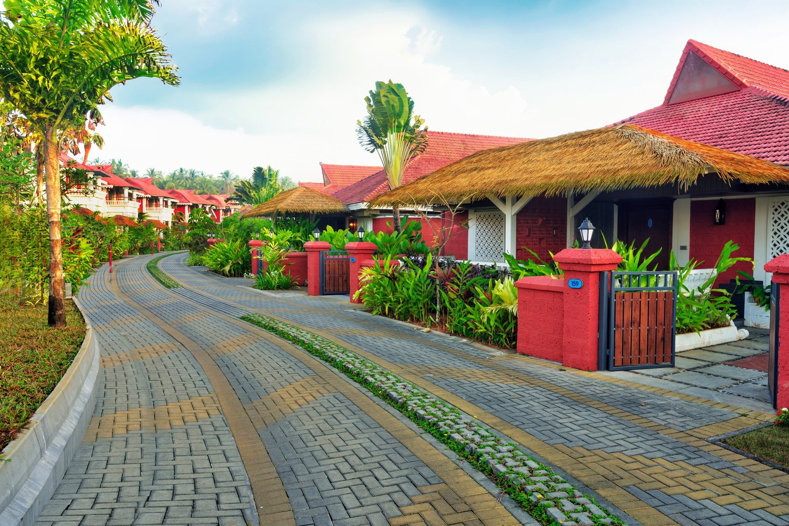 Landscaped resort entrance with a curving stone path